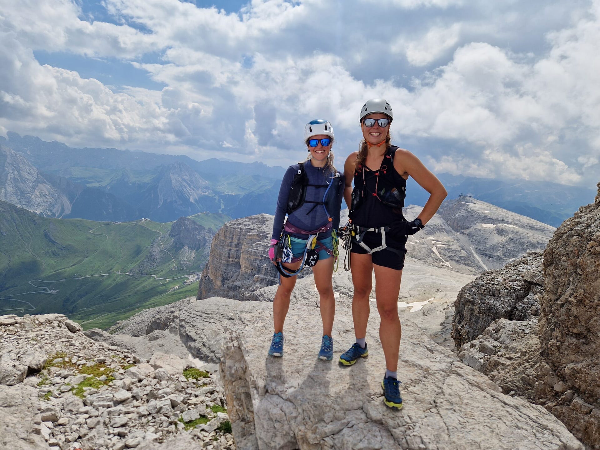 Women with via ferrata gear on the summit of Piz Boe in Italian Dolomites